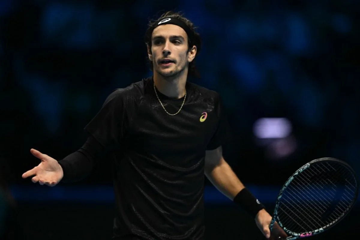 Italy's Lorenzo Musetti reacts during his match against Spain's Carlos Alcaraz at the ATP Finals tennis tournament in Turin on November 13, 2025. Marco BERTORELLO / AFP