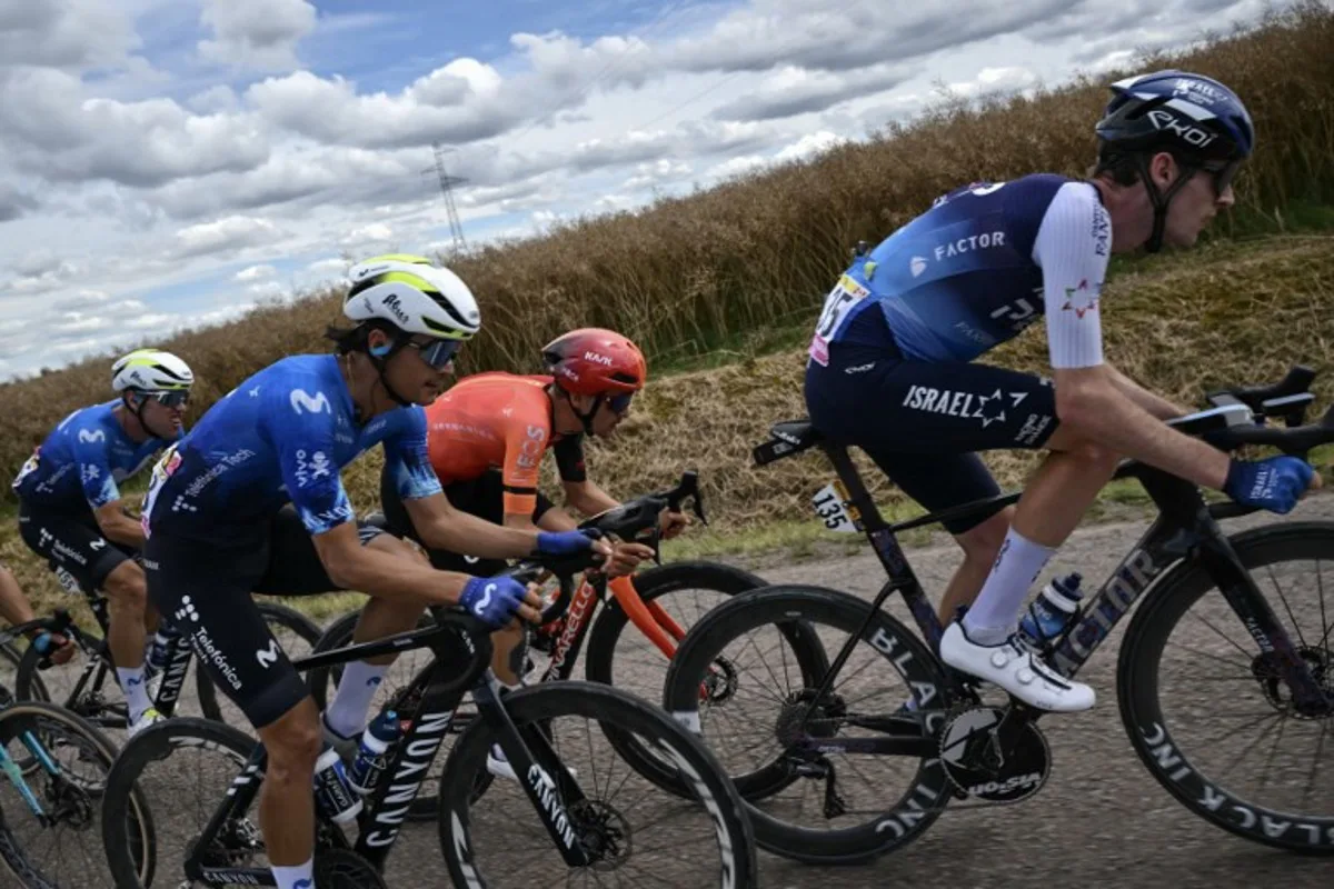 Israel - Premier Tech team's Canadian rider Derek Gee (R) and Movistar Team's Spanish rider Javier Romo (L) cycle in a breakaway during the 9th stage of the 111th edition of the Tour de France cycling race, 199km stage departing and finishing in Troyes, on July 7, 2024.  Marco BERTORELLO / AFP