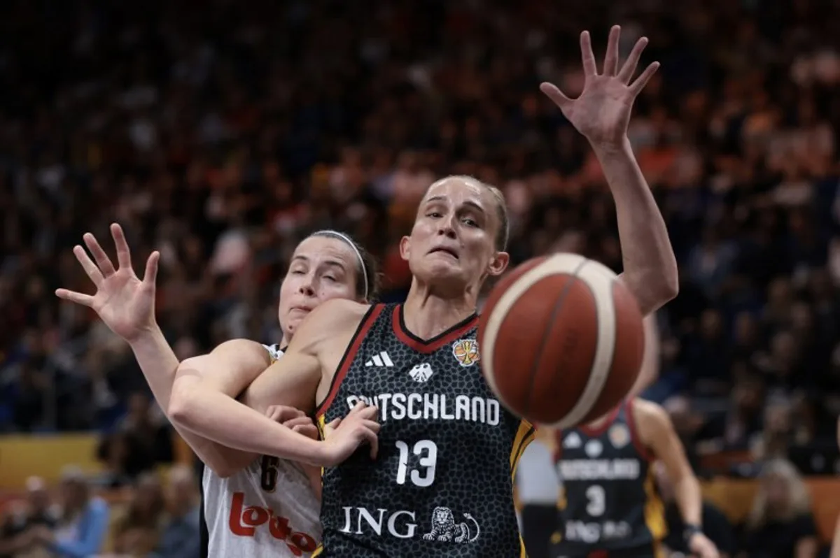 Germany's shooting guard #13 Leonie Fiebich and Belgium's small forward #06 Antonia Delaere fight for the ball during the FIBA Women's Basketball World Cup quarter-final match between Belgium and Germany at the Berlin Arena in Berlin on September 10, 2026. Ronny HARTMANN / AFP