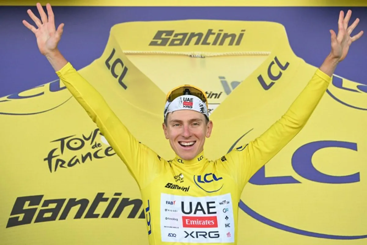 UAE Team Emirates - XRG team's Slovenian rider Tadej Pogacar celebrates on the podium with the overall leader's yellow jersey after the 5th stage of the 112th edition of the Tour de France cycling race, 33 km individual time trial starting and finishing in Caen, northwestern France, on July 9, 2025. Loic VENANCE / AFP