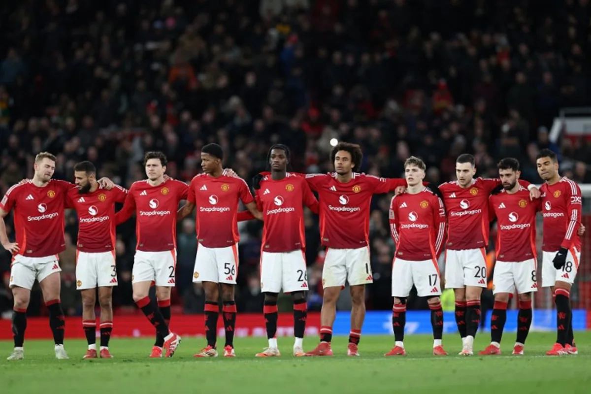 Manchester United's players line up during the penalty shoot-out in the English FA Cup fifth round football match between Manchester United and Fulham at Old Trafford in Manchester, north west England, on March 2, 2025.  Fulham won the game 4-3 on penalties after finishing 1-1 after extra time. Darren Staples / AFP