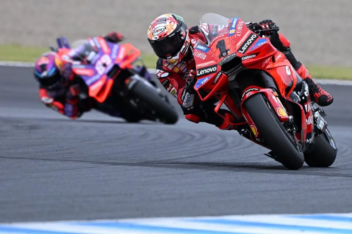 Ducati Lenovo Team rider Francesco Bagnaia of Italy (R) leads Prima Pramac Racing rider Jorge Martin of Spain (L) during the MotoGP Japanese Grand Prix at the Mobility Resort Motegi in Motegi, Tochigi prefecture on October 6, 2024.  Toshifumi KITAMURA / AFP