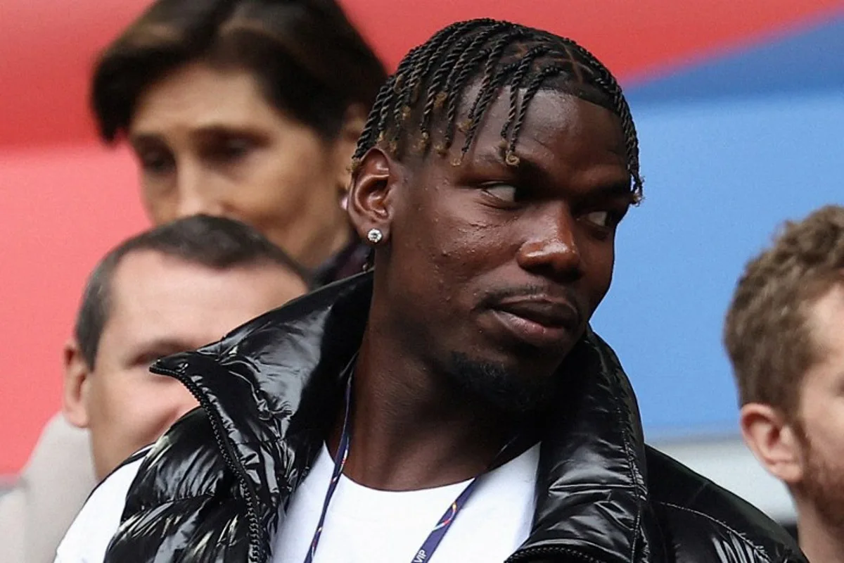 (FILES) French midfielder paul Pogba (L) attends the UEFA Euro 2024 round of 16 football match between France and Belgium at the Duesseldorf Arena in Duesseldorf on July 1, 2024. The French midfielder's drug ban has been cut to 18 months from 4 years the Court of Arbitration for Sport announced on October 4, 2024. FRANCK FIFE / AFP