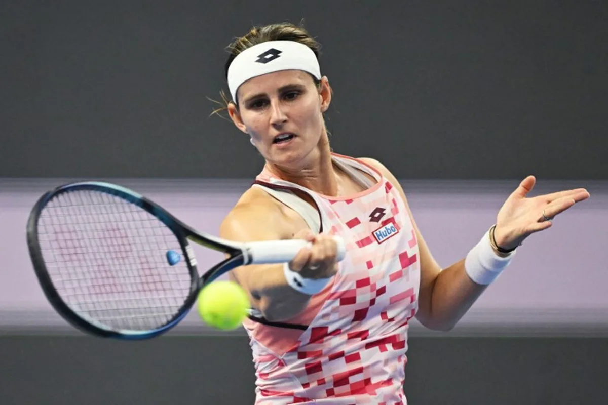 Belgium's Greet Minnen hits a return to China's Zhang Shuai during their women's singles match at the China Open tennis tournament in Beijing on September 29, 2024.  GREG BAKER / AFP