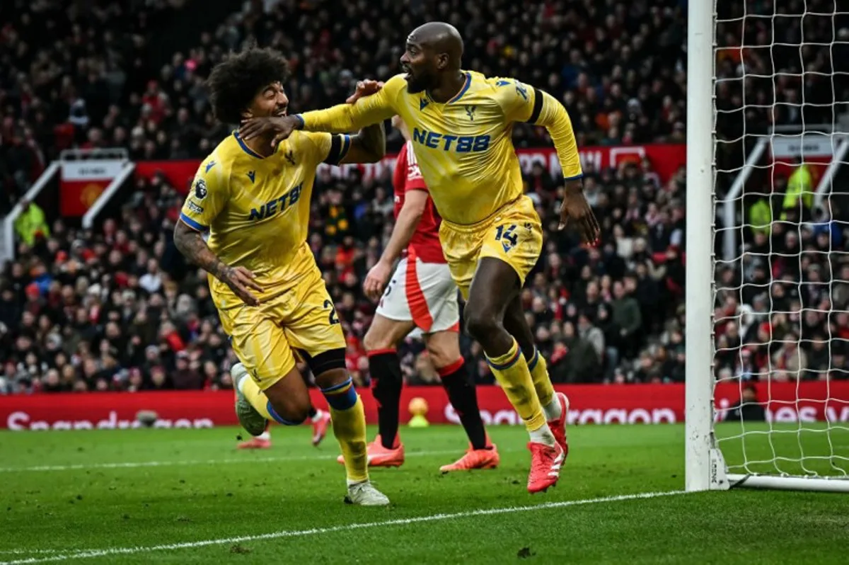 Crystal Palace's French striker #14 Jean-Philippe Mateta (R) celebrates with Crystal Palace's US defender #26 Chris Richards (L) after scoring his team first goal during the English Premier League football match between Manchester United and Crystal Palace at Old Trafford in Manchester, north west England, on February 2, 2025.  Paul ELLIS / AFP