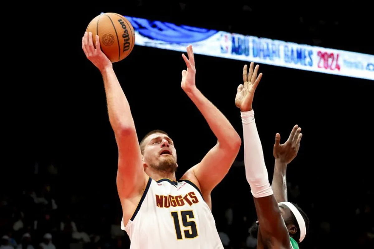 Denver Nuggets' center #15 Nikola Jokic jumps to shoot during the NBA Preseason game between the Boston Celtics and the Denver Nuggets at the Etihad Arena in Abu Dhabi on October 6, 2024.  Fadel Senna / AFP