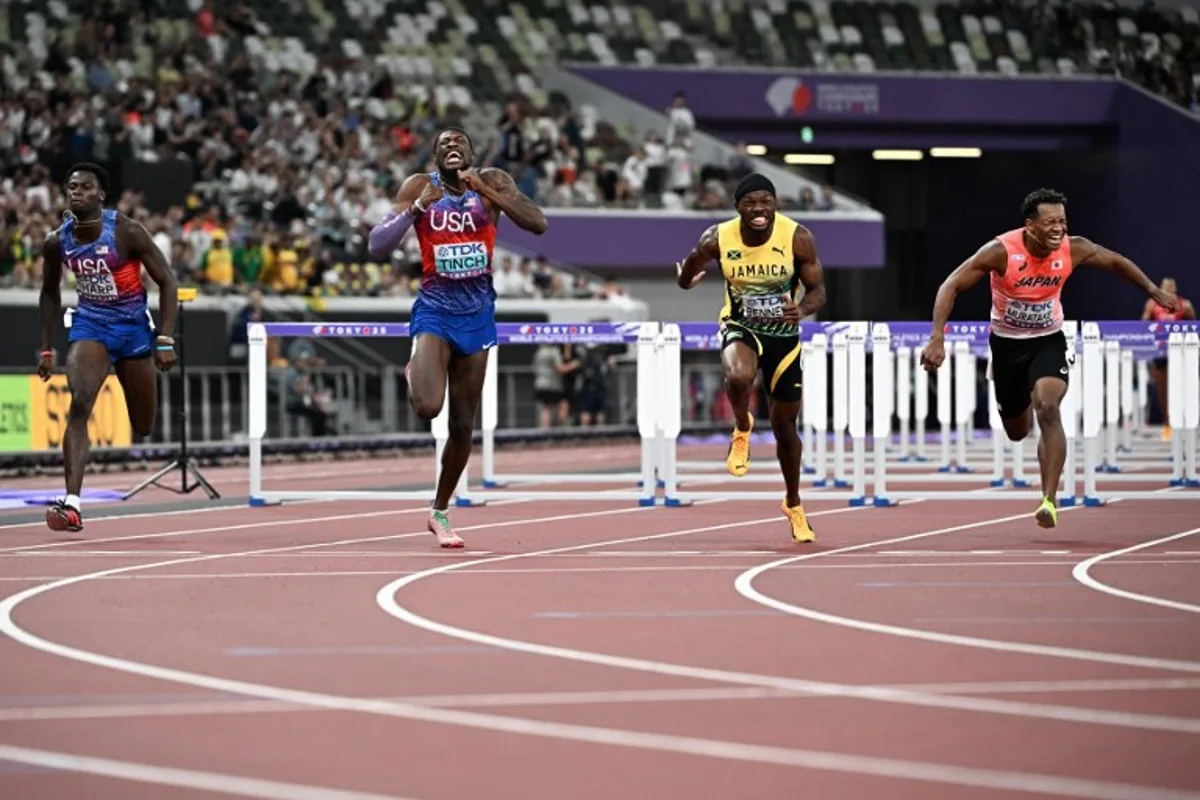 (L-R) US' athlete Ja'Kobe Tharp, US' athlete Cordell Tinch, Jamaica's Orlando Bennett and Japan's athlete Rachid Muratake cross the finish line in the men's 110m hurdles final during the World Athletics Championships in Tokyo on September 16, 2025. Jewel SAMAD / AFP