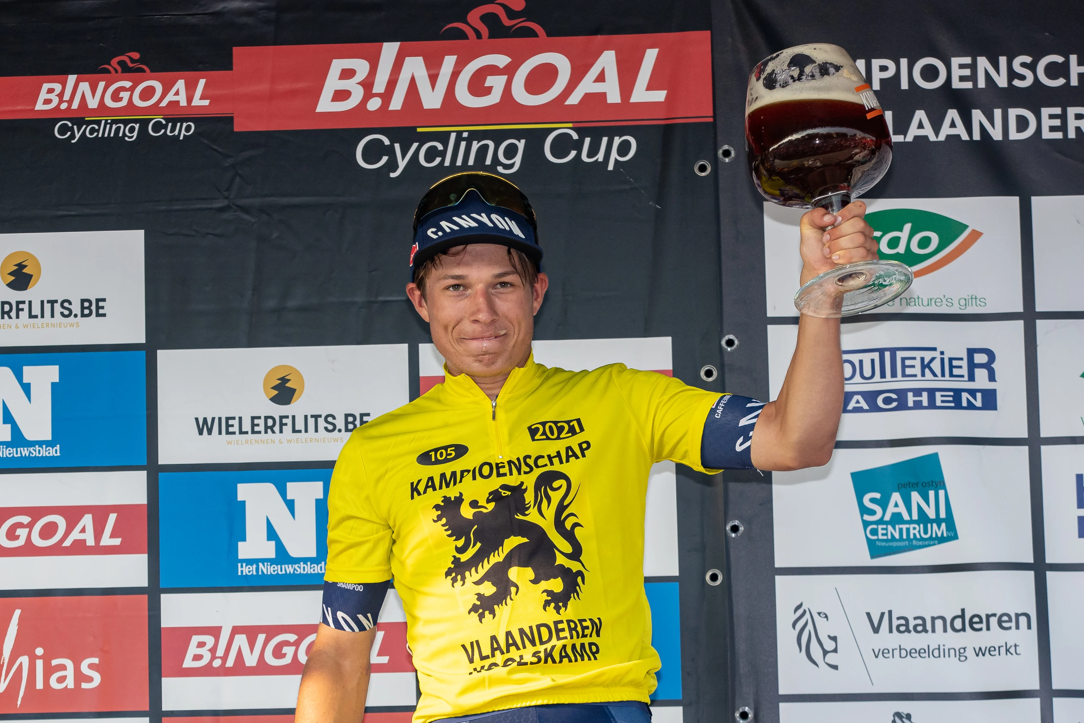 Belgian Jasper Philipsen of Alpecin-Fenix celebrates on the podium after winning the 105th edition of the Kamioenschap van Vlaanderen one day cycling race, 195,3 km from Koolskamp to Koolskamp, Friday 17 September 2021, the eighth stage (out of 9) of the Bingoal cycling cup. BELGA PHOTO KURT DESPLENTER