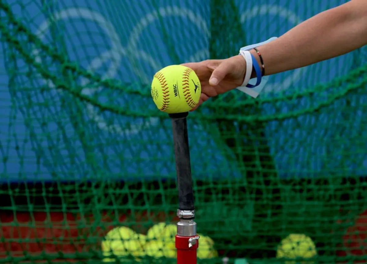 Unidentified Italy's softball player puts a ball onto the tee at the training area prior to the Tokyo 2020 Olympic Games softball opening round game between Italy and Australia at Fukushima Azuma Baseball Stadium in Fukushima, Japan, on July 22, 2021. KAZUHIRO FUJIHARA / AFP