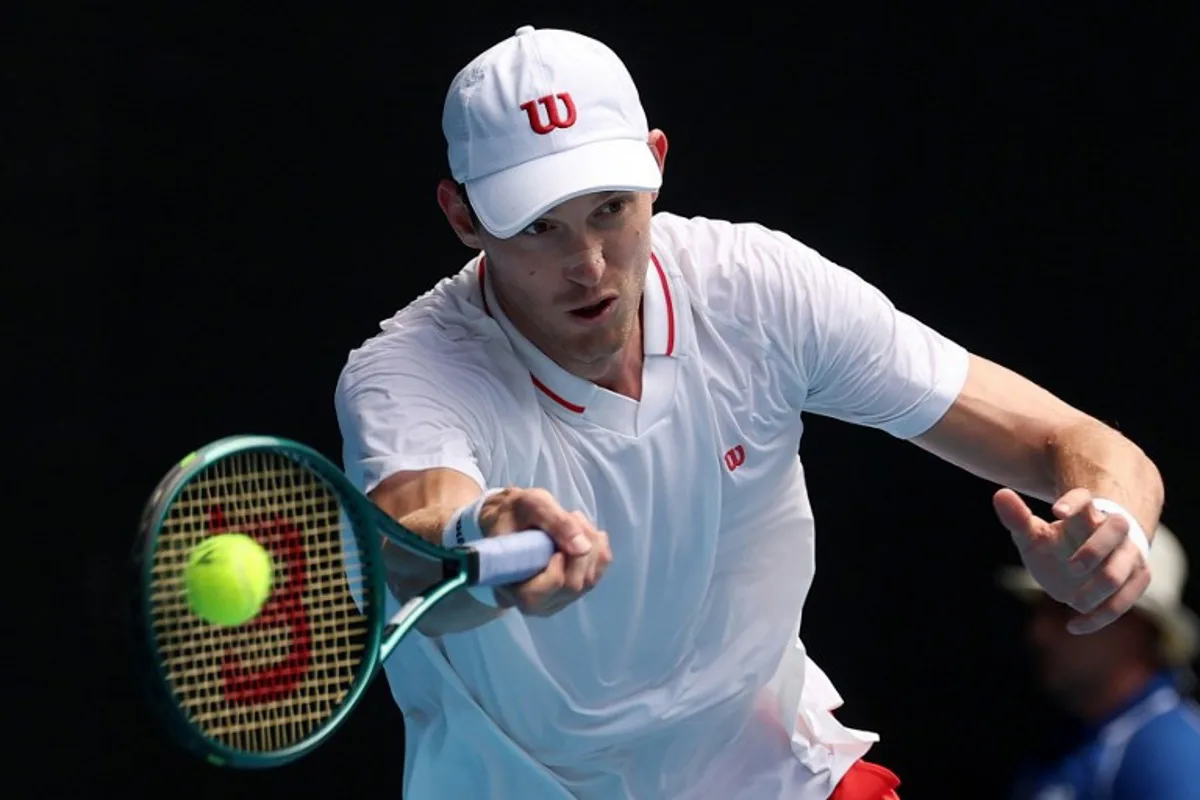 Chile's Nicolas Jarry hits a return against Italy's Jannik Sinner during their men's singles match on day two of the Australian Open tennis tournament in Melbourne on January 13, 2025.  DAVID GRAY / AFP