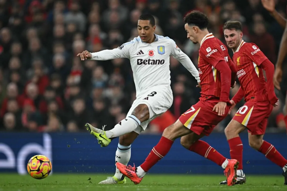 Aston Villa's Belgian midfielder #08 Youri Tielemans (L) passes the ball during the English Premier League football match between Liverpool and Aston Villa at Anfield in Liverpool, north west England on November 9, 2024.  Paul ELLIS / AFP