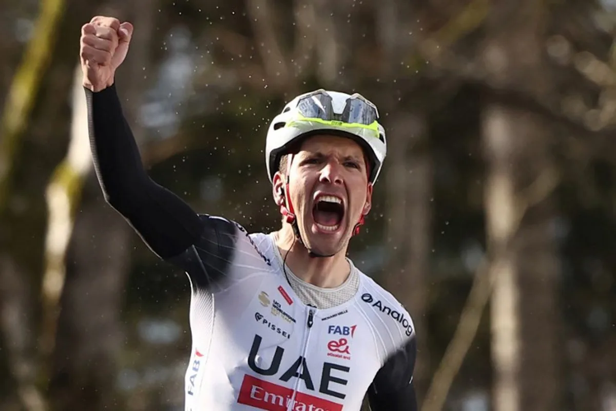 UAE Team Emirates XRG's Portuguese rider Joao Almeida celebrates after crossing the finish line to win the 4th stage of the Paris-Nice cycling race, 163,4 km between Vichy and La Loge des Gardes, on March 12, 2025. Anne-Christine POUJOULAT / AFP