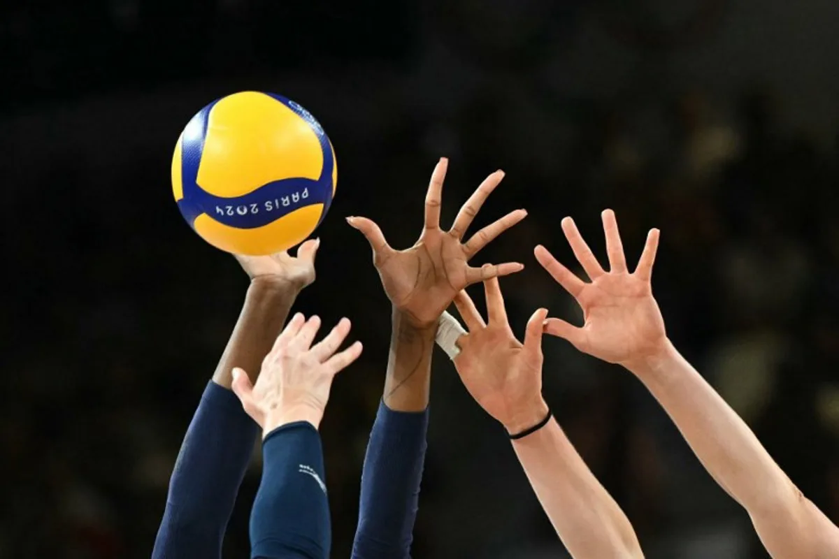 Players jump to hit the ball in the women's volleyball gold medal match between USA and Italy at the South Paris Arena 1 in Paris during the Paris 2024 Olympic Games on August 11, 2024.  Natalia KOLESNIKOVA / AFP