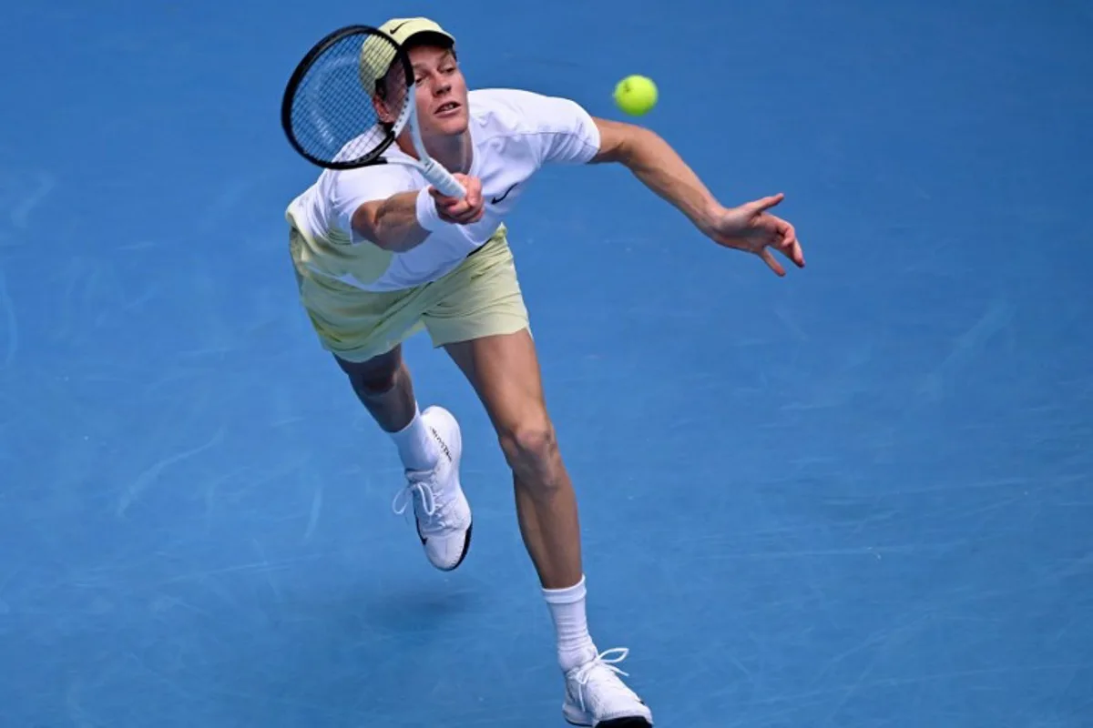 Italy's Jannik Sinner hits a return against Denmark's Holger Rune during their men's singles match on day nine of the Australian Open tennis tournament in Melbourne on January 20, 2025.  WILLIAM WEST / AFP