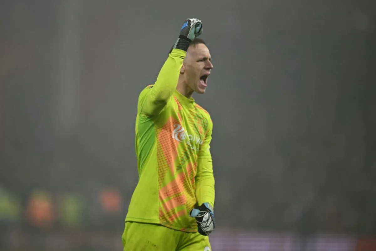 Nottingham Forest's Belgian goalkeeper #26 Matz Sels celebrates on the final whistle in the English Premier League football match between Nottingham Forest and Tottenham Hotspur at The City Ground in Nottingham, central England, on December 26, 2024. Forest won the game 1-0. Ben STANSALL / AFP