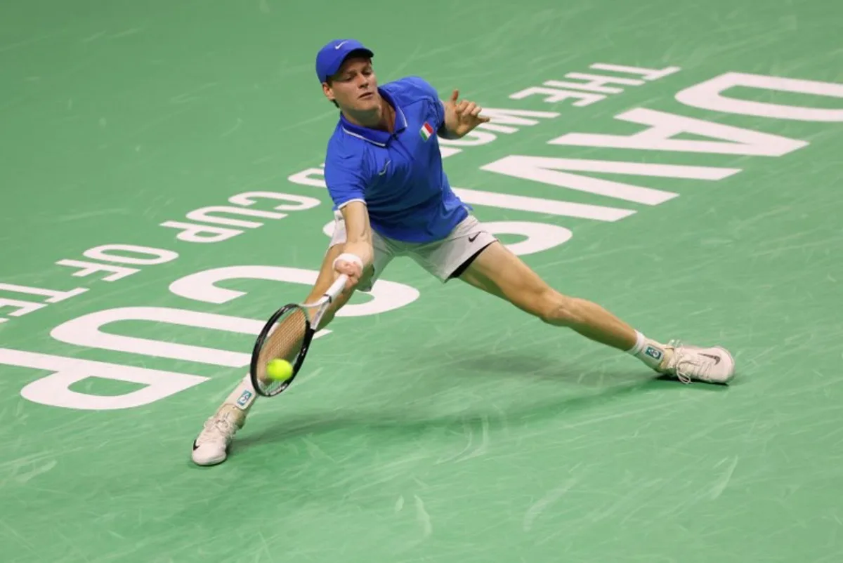 Jannik Sinner of Team Italy returns a shot to Alex de Minaur of Team Australia during their semi-final singles match between Italy and Australia at the Davis Cup Finals at the Palacio de Deportes Jose Maria Martin Carpena arena in Malaga, southern Spain, on November 23, 2024.  Thomas COEX / AFP