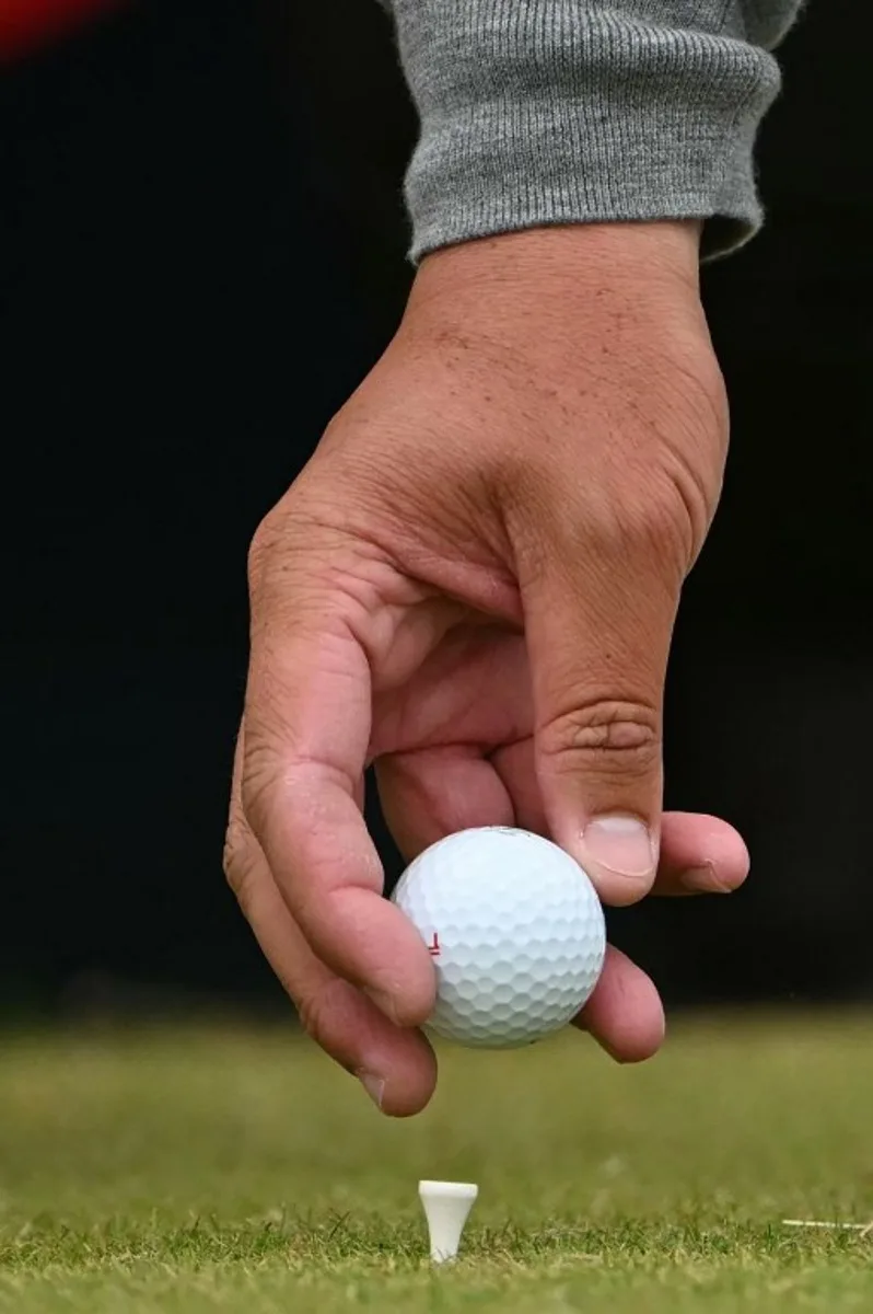 South Africa's Thriston Lawrence places his ball on it's tee on the 11th during his third round, on day three of the 152nd British Open Golf Championship at Royal Troon on the south west coast of Scotland on July 20, 2024.  ANDY BUCHANAN / AFP