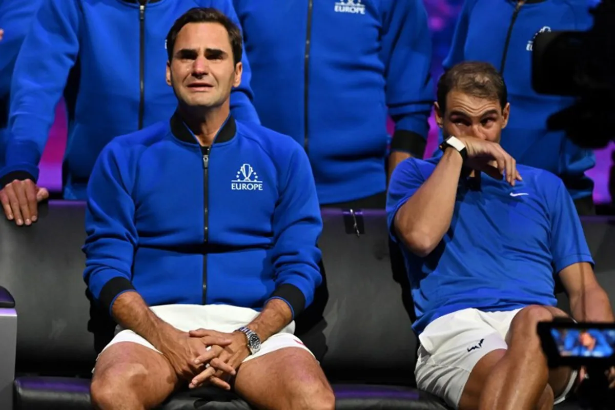 Switzerland's Roger Federer (L) sheds a tear after playing his final match, a doubles with Spain's Rafael Nadal (R) of Team Europe against USA's Jack Sock and USA's Frances Tiafoe of Team World in the 2022 Laver Cup at the O2 Arena in London, early on September 24, 2022. Roger Federer brings the curtain down on his spectacular career in a "super special" match alongside long-time rival Rafael Nadal at the Laver Cup in London on Friday. Glyn KIRK / AFP