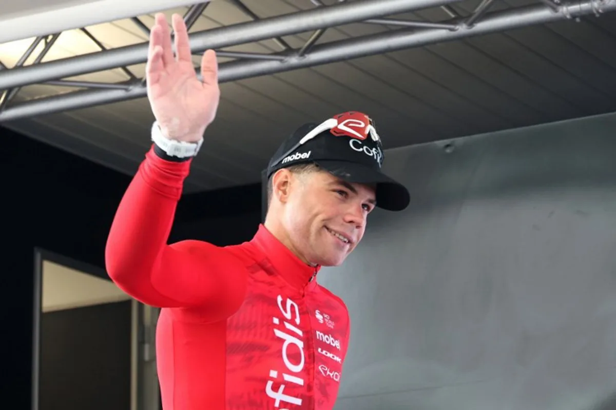 Team Cofidis' Belgium rider Milan Fretin celebrates on the podium after winning the first stage of the "4 jours de Dunkerque" (Four days of Dunkirk) cycling race, 168km from Dunkirk to Le Touquet, in northern France, on May 14, 2024.  FRANCOIS LO PRESTI / AFP