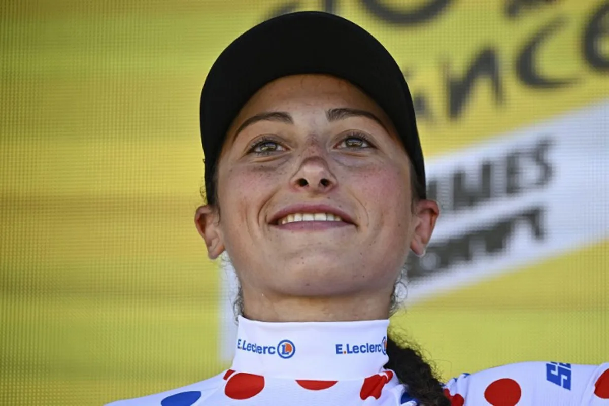 Laboral Kutxa - Fundacion Euskadi team's Italian rider Cristina Tonetti celebrates on the podium with the best climber's polka dot (dotted) jersey after the first stage (out of 8) of the third edition of the Women's Tour de France cycling race, 123 km between Rotterdam and The Hague, on August 12, 2024. JULIEN DE ROSA / AFP