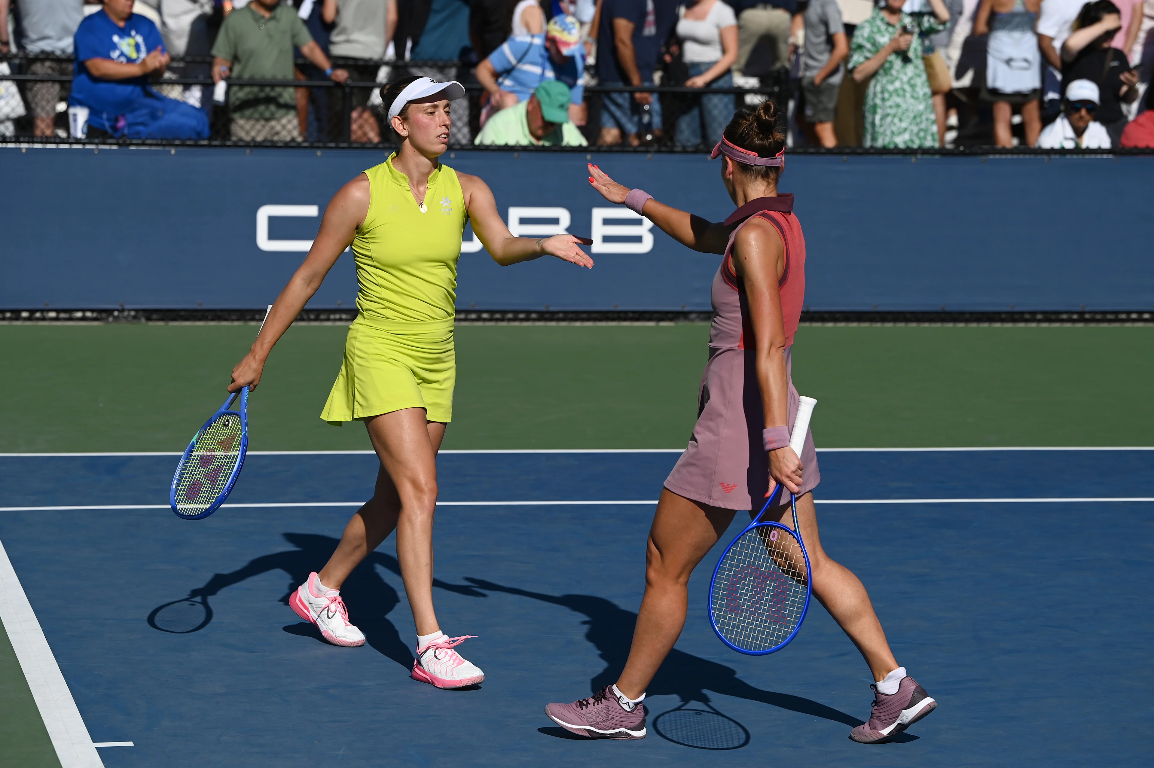 Belgian Elise Mertens (yellow) and Veronika Kudermetova (pink) pictured during a tennis match against US pair Brantmeier-Hamilton, in the second round of the women's doubles of the 2025 US Open Grand Slam tennis tournament in New York City, USA, Saturday 30 August 2025. BELGA PHOTO TONY BEHAR