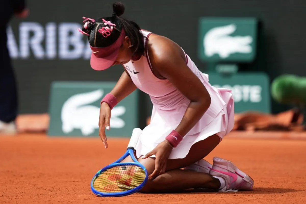 Japan's Naomi Osaka looks at her hand during her women's singles match against Spain's Paula Badosa on day 2 of the French Open tennis tournament on Court Philippe-Chatrier at the Roland-Garros Complex in Paris on May 26, 2025. Dimitar DILKOFF / AFP