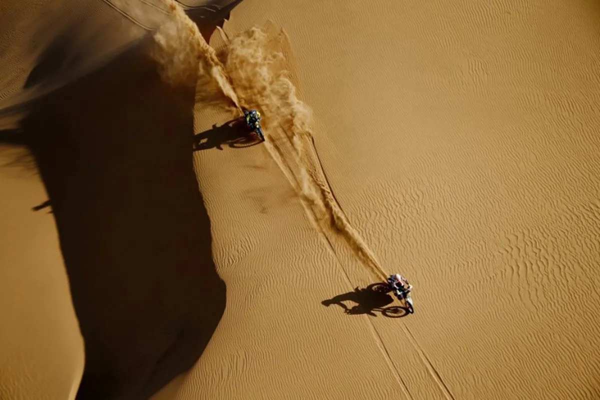 Polish biker Konrad Dabrowski (L) and Spain's Sherco biker Lorenzo Santolino compete during the Stage 8 of the Dakar Rally 2022 between al-Dawadimi and Wadi Ad-Dawasir in Saudi Arabia, on January 10, 2022.  FRANCK FIFE / AFP