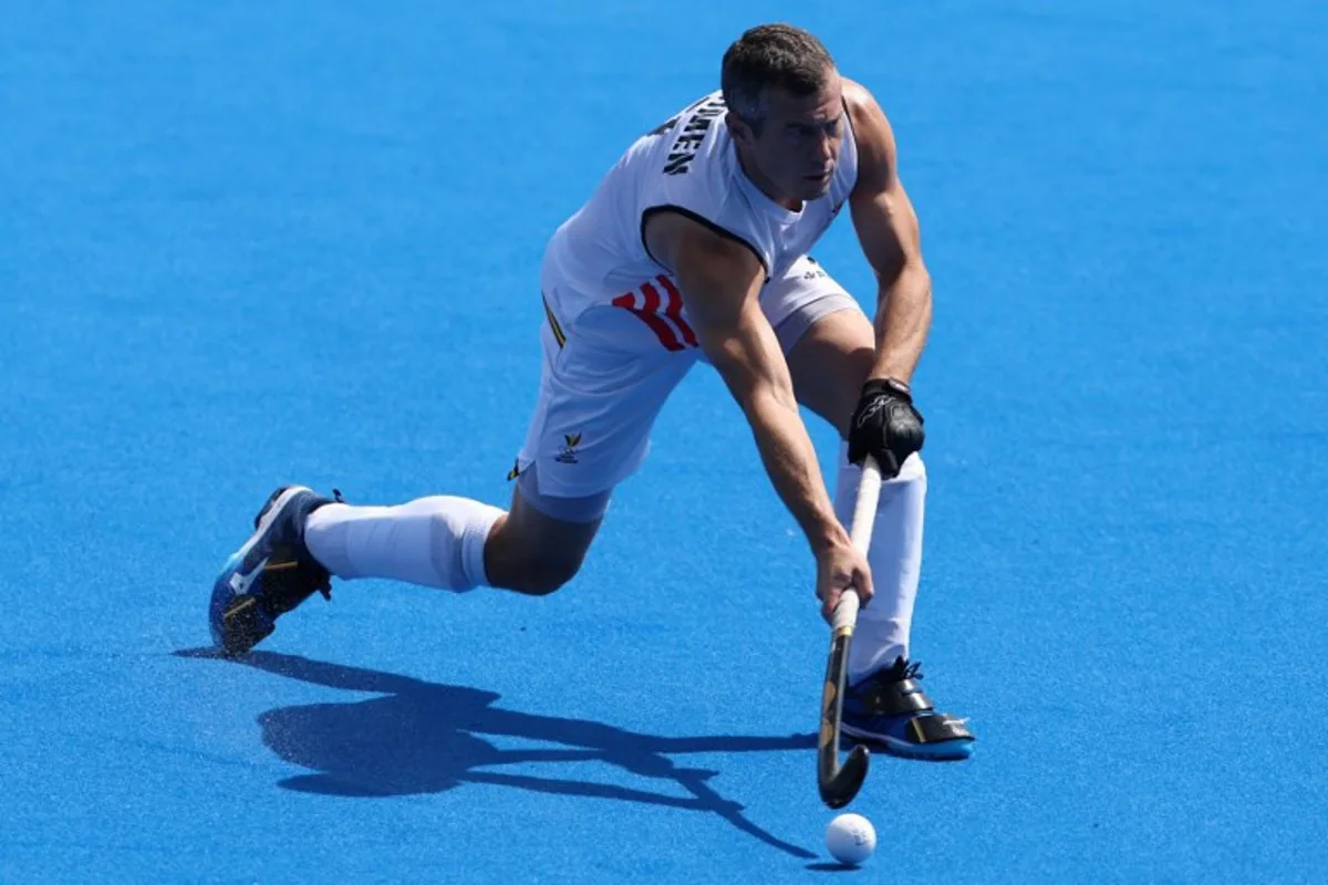 Belgium's midfielder #07 John-John Dohmen passes the ball in the men's quarter-final field hockey match between Belgium and Spain during the Paris 2024 Olympic Games at the Yves-du-Manoir Stadium in Colombes on August 4, 2024.  Ahmad GHARABLI / AFP