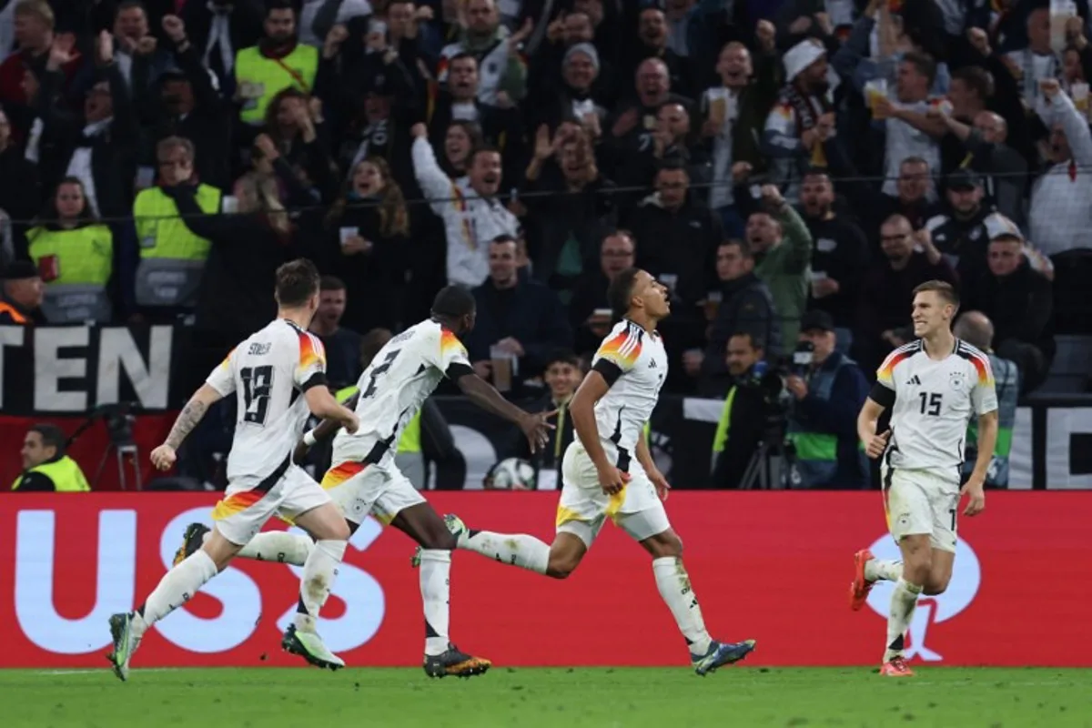 Germany's players celebrate after midfielder #07 Jamie Leweling (2R) scored the opening goal during the UEFA Nations League, League A Group A3 football match between Germany and the Netherlands in Munich, southern Germany on October 14, 2024.  Alexandra BEIER / AFP