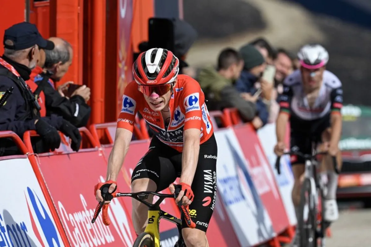 Overall race leader Team Visma-Lease a bike's Danish rider Jonas Vingegaard crosses the finish line of the 17th stage of the Vuelta a Espana, a 143 km race between  O Barco de Valdeorras and Alto de El Morredero, Ponferrada, on September 10, 2025.    Miguel RIOPA / AFP