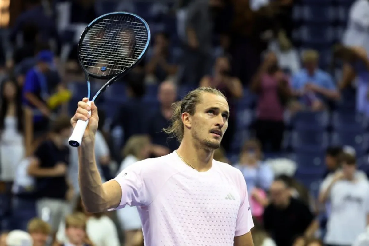 Germany's Alexander Zverev waves his racquet to the crowd after defeating Chile's Alejandro Tabilo during their men's singles third-round tennis match on day seven of the US Open tennis tournament at the USTA Billie Jean King National Tennis Center in New York City in the early hours of September 6, 2026. Leonardo MUNOZ / AFP