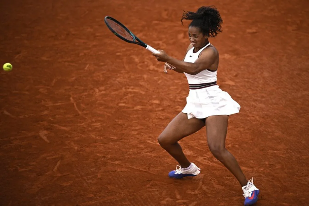US Robin Montgomery plays a forehand return to France's Diane Parry during their women's singles match on day 2 of the French Open tennis tournament at the Roland-Garros Complex in Paris on May 26, 2025. JULIEN DE ROSA / AFP