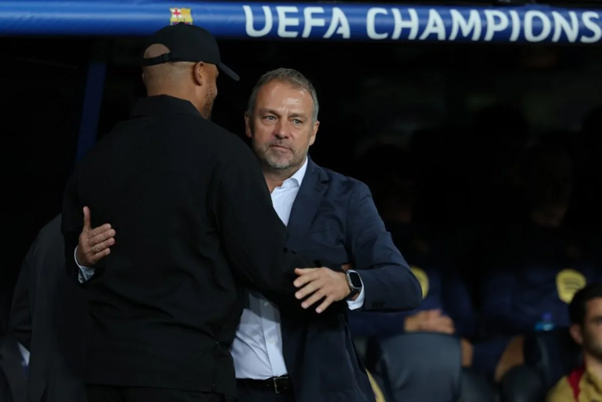 Bayern Munich's Belgian coach Vincent Kompany (L) and Barcelona's German coach Hans-Dieter Flick hug each other before the UEFA Champions League, league phase day 3 football match between FC Barcelona and FC Bayern Munich at the Estadi Olimpic Lluis Companys in Barcelona on October 23, 2024.  LLUIS GENE / AFP