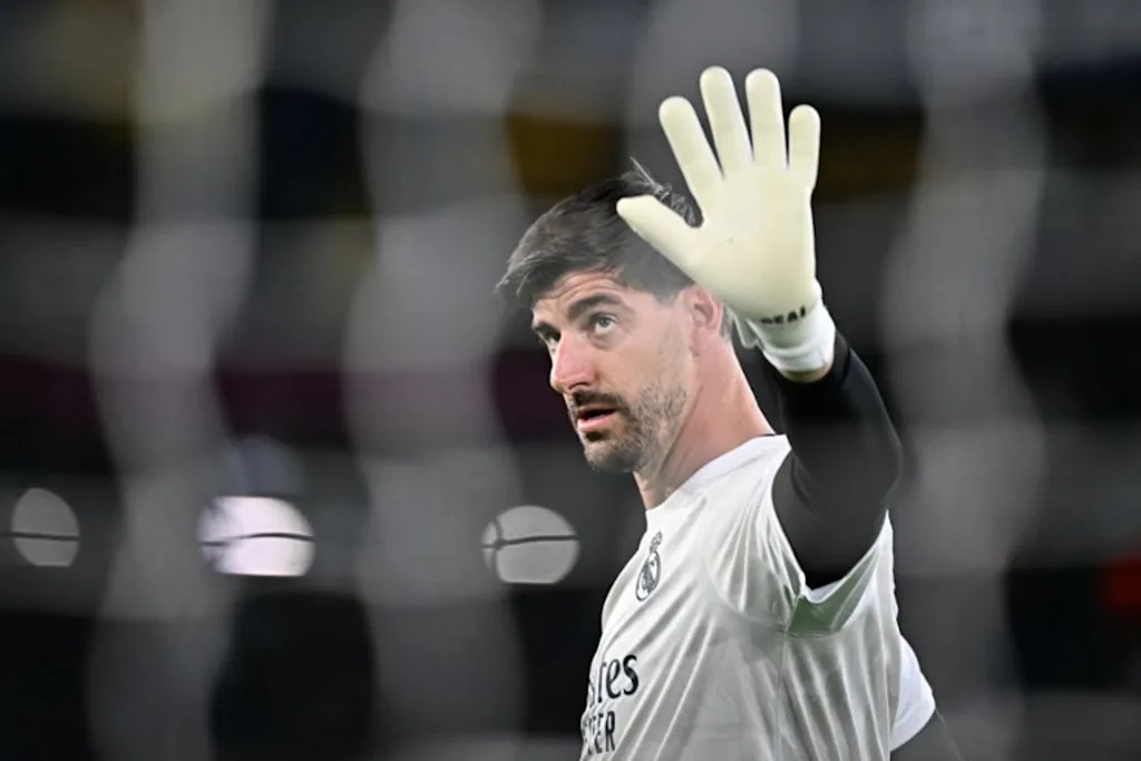 Real Madrid's Belgian goalkeeper #01 Thibaut Courtois warms up before the UEFA Champions Leaugue - 1st round day 2 football match between AS Roma and Real Madrid at the Olympic Stadium in Rome on October 14, 2026. Filippo MONTEFORTE / AFP