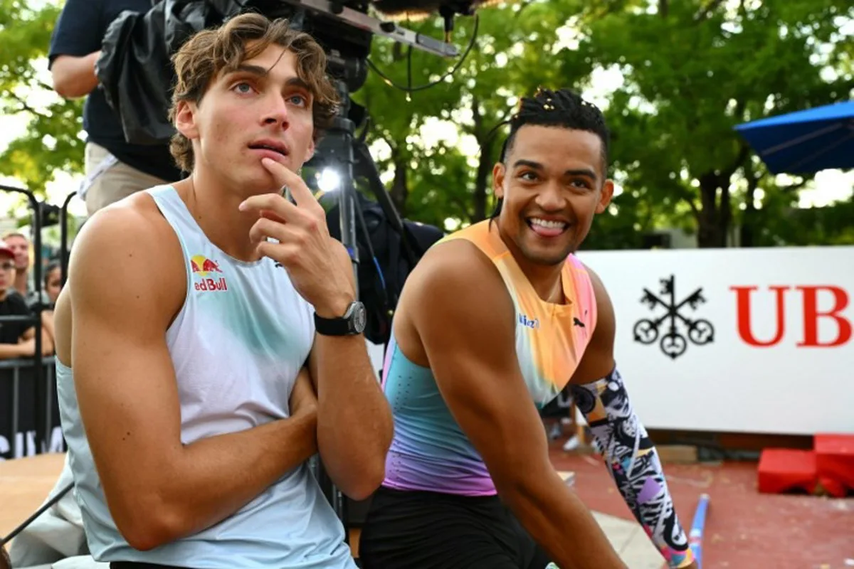Sweden's Armand Duplantis and Greece's Emmanouil Karalis react on the sidelines as they compete in the men's Pole Vault during the World Athletics Diamond League athletics meeting at the Stade Olympique de la Pontaise in Lausanne, on August 20, 2026. Fabrice COFFRINI / AFP