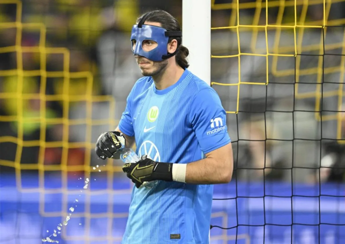 Wolfsburg's Polish goalkeeper #01 Kamil Grabara looks on during the German first division Bundesliga football match between Borussia Dortmund and VfL Wolfsburg in Dortmund on September 21, 2025.  INA FASSBENDER / AFP