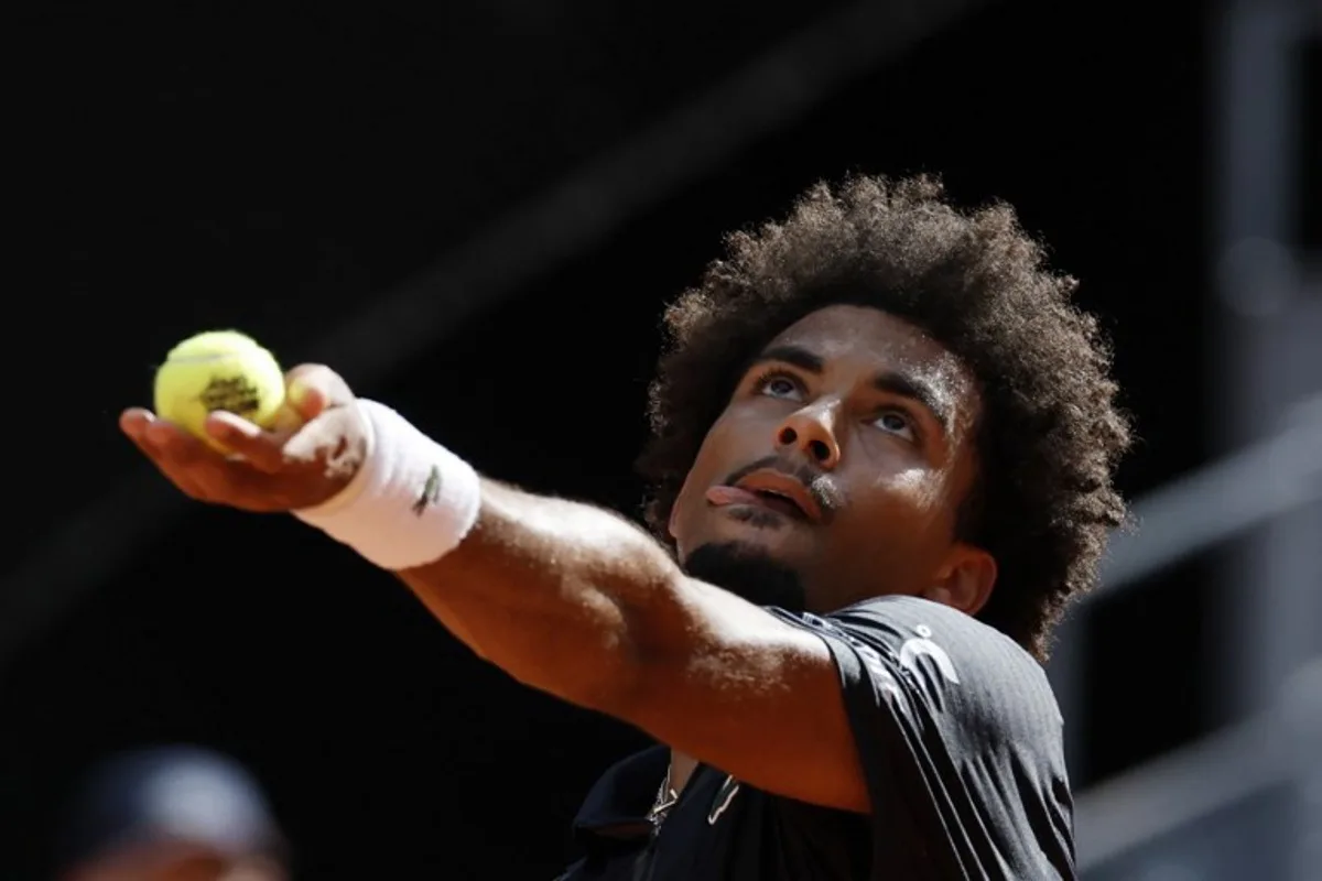France's Arthur Fils serves to Italy's Jannik Sinner during their 2026 ATP Tour Madrid Open tennis tournament semi-final singles match at the Caja Magica in Madrid, on May 1, 2026.  Oscar DEL POZO / AFP