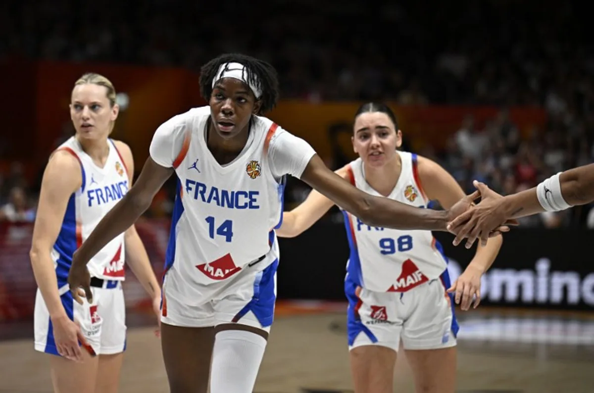 France's center #14 Dominique Malonga celebrates a point during the 2026 FIBA Women's Basketball World Cup semi-final match between France and Germany in Berlin on September 12, 2026.  Tobias SCHWARZ / AFP