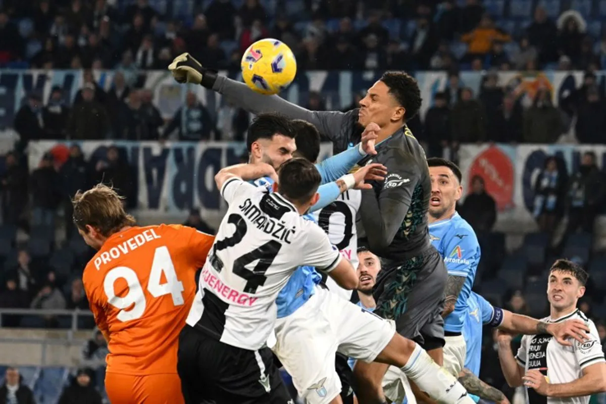 Udinese's German-Nigerian goalkeeper #40 Maduka Okoye pushes the ball during the Italian Serie A football match between Lazio and Udinese, at Olympic stadium in Rome, on March 11, 2024 . Alberto PIZZOLI / AFP