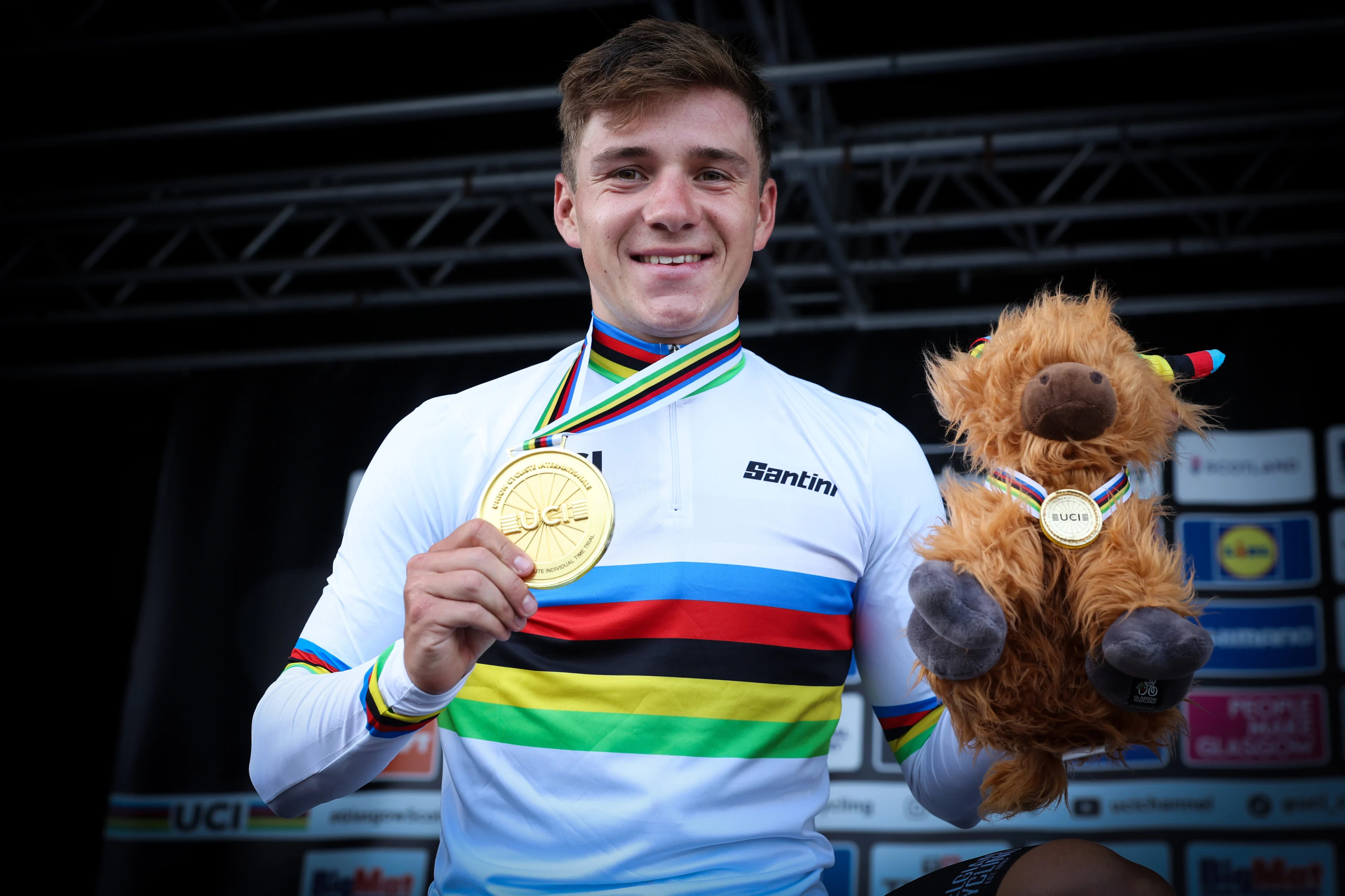 Belgian Remco Evenepoel celebrates on the podium with his gold medal after winning the elite men time trial race at the UCI World Championships Cycling, in Glasgow, Scotland, Friday 11 August 2023. UCI organizes the worlds with all cycling disciplines, road cycling, indoor cycling, mountain bike, BMX racing, road para-cycling and indoor para-cycling, in Glasgow from 03 to 13 August. BELGA PHOTO DAVID PINTENS