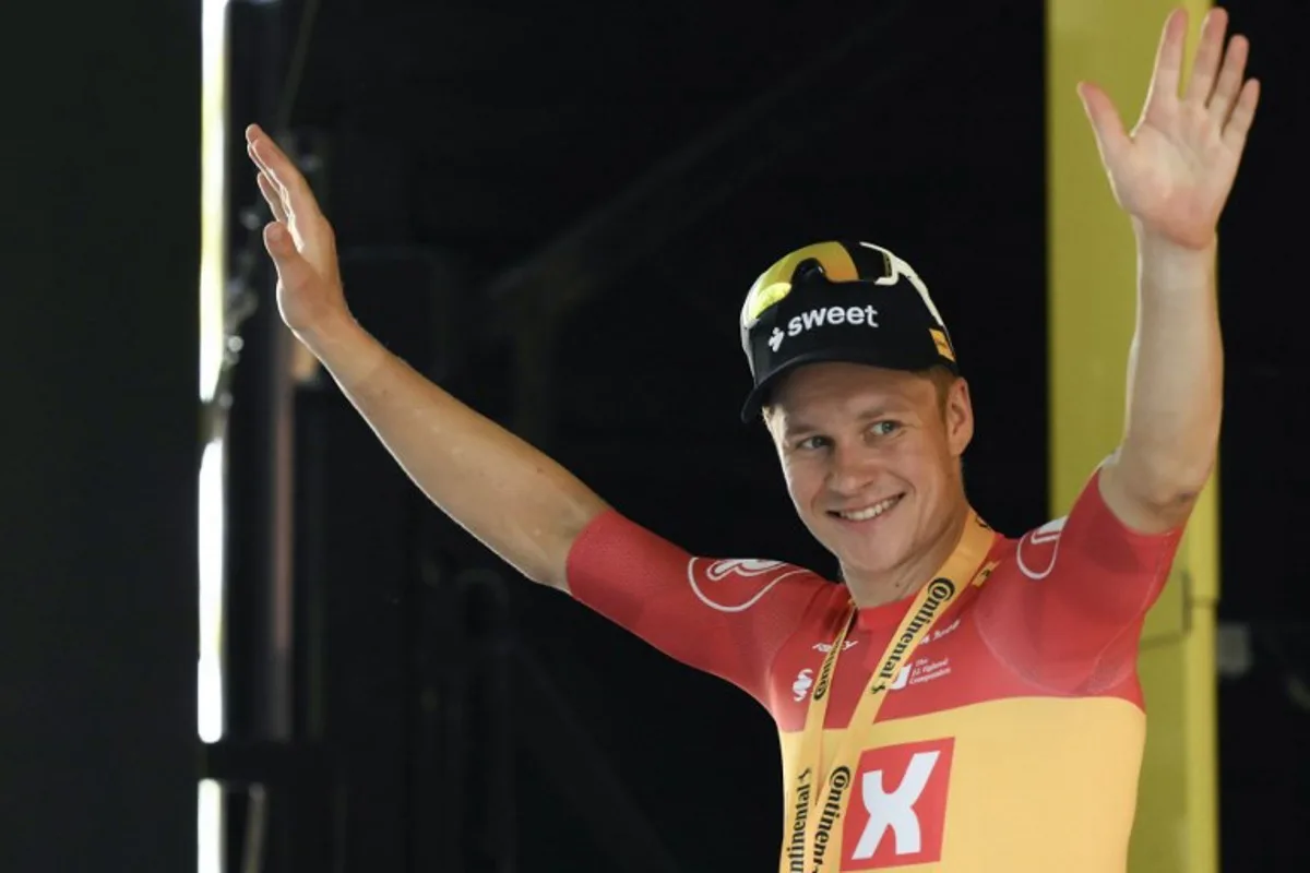 Uno-X Mobility team's Norwegian rider Jonas Abrahamsen celebrates on the podium after winning the 11th stage of the 112th edition of the Tour de France cycling race, 156.8 km starting and finishing in Toulouse, southwestern France, on July 16, 2025. Marco BERTORELLO / AFP