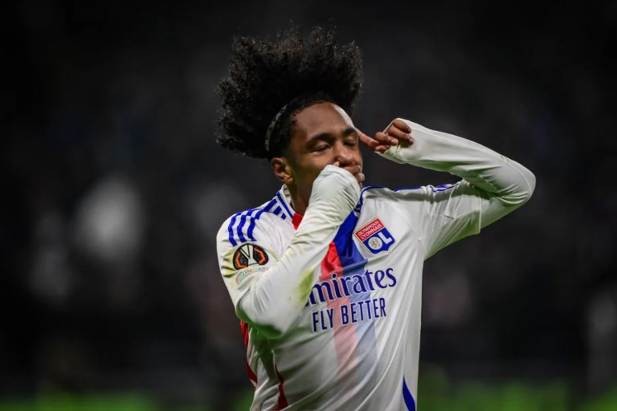 Lyon's Belgian forward #11 Malick Fofana celebrates scoring his team's second goal during the UEFA Europa League, league phase day 6, football match between Olympique Lyonnais (OL) and Eintracht Frankfurt at the Groupama Stadium in Decines-Charpieu, central-eastern France, on December 12, 2024.  OLIVIER CHASSIGNOLE / AFP