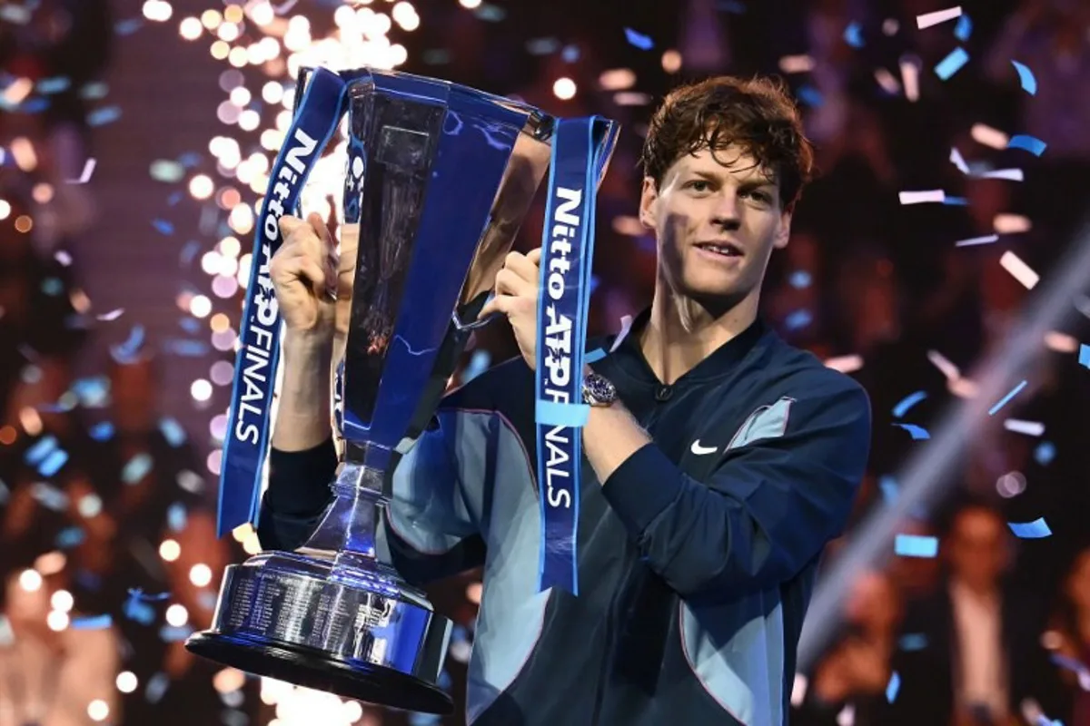 Italy's Jannik Sinner lifts the trophy after winning the final against USA's Taylor Fritz at the ATP Finals tennis tournament in Turin on November 17, 2024.  Marco BERTORELLO / AFP