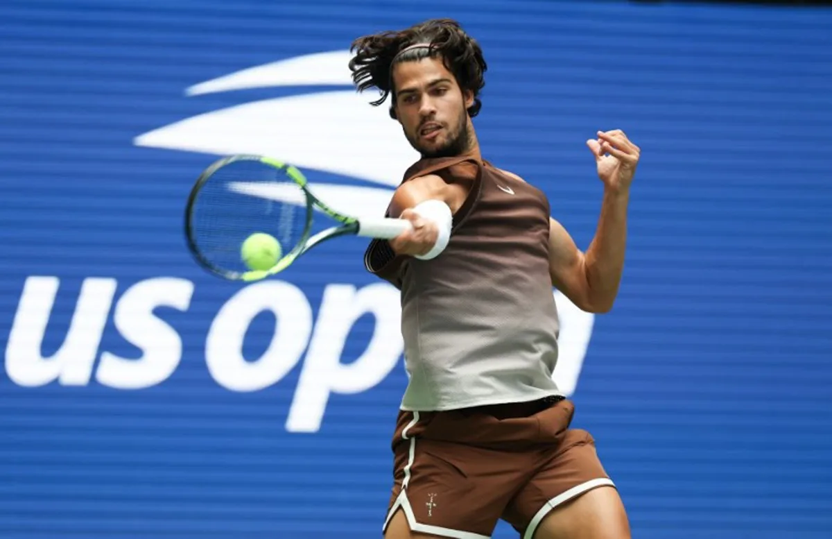Spain's Carlos Alcaraz hits a return to Russia's Roman Safiullin during their men's singles first round tennis match on day two of the US Open tennis tournament at the USTA Billie Jean King National Tennis Center in New York City on August 31, 2026.  TIMOTHY A. CLARY / AFP