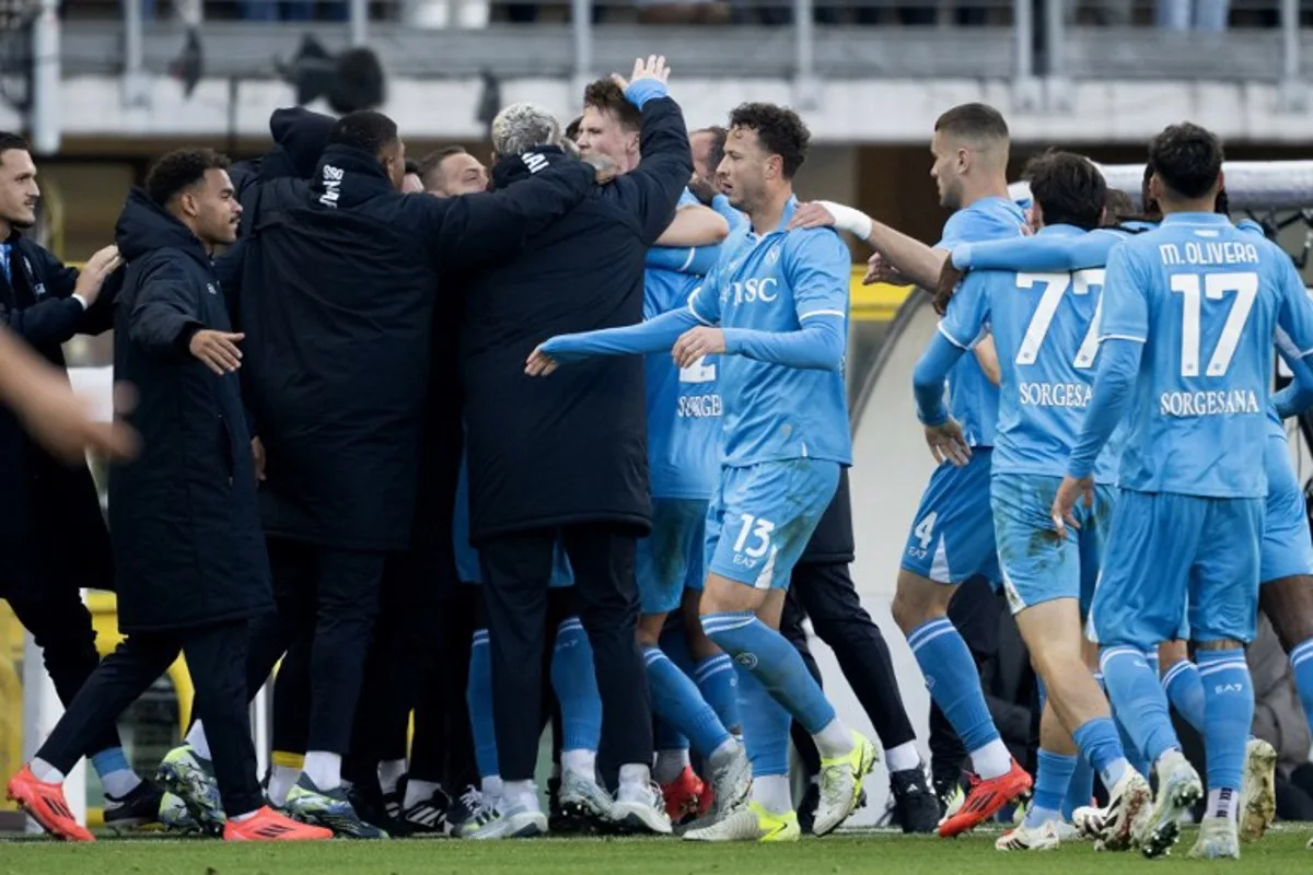 Napoli's players and staff congratulate Napoli's Scottish midfielder #08 Scott McTominay (C) after scoring Napoli's first goal during the Italian Serie A football match between Torino FC and SSC Napoli at the Grande Torino Stadium in Turin on December 1, 2024.  MARCO BERTORELLO / AFP