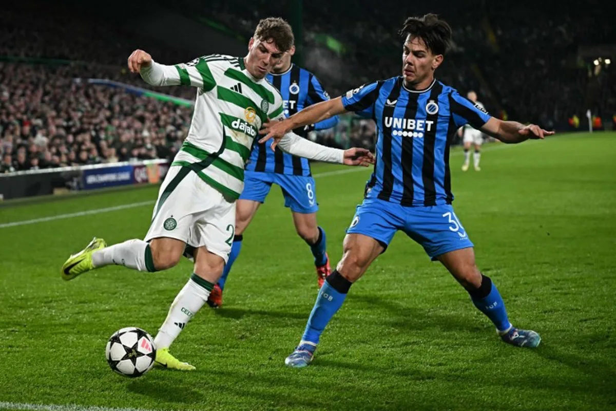 Club Brugge's Swiss midfielder #30 Ardon Jashari (R) defends from Celtic's Belgian midfielder #27 Arne Engels during the UEFA Champions League football match between Celtic and Club Brugge at Celtic Park stadium in Glasgow, Scotland on November 27, 2024.   Paul ELLIS / AFP