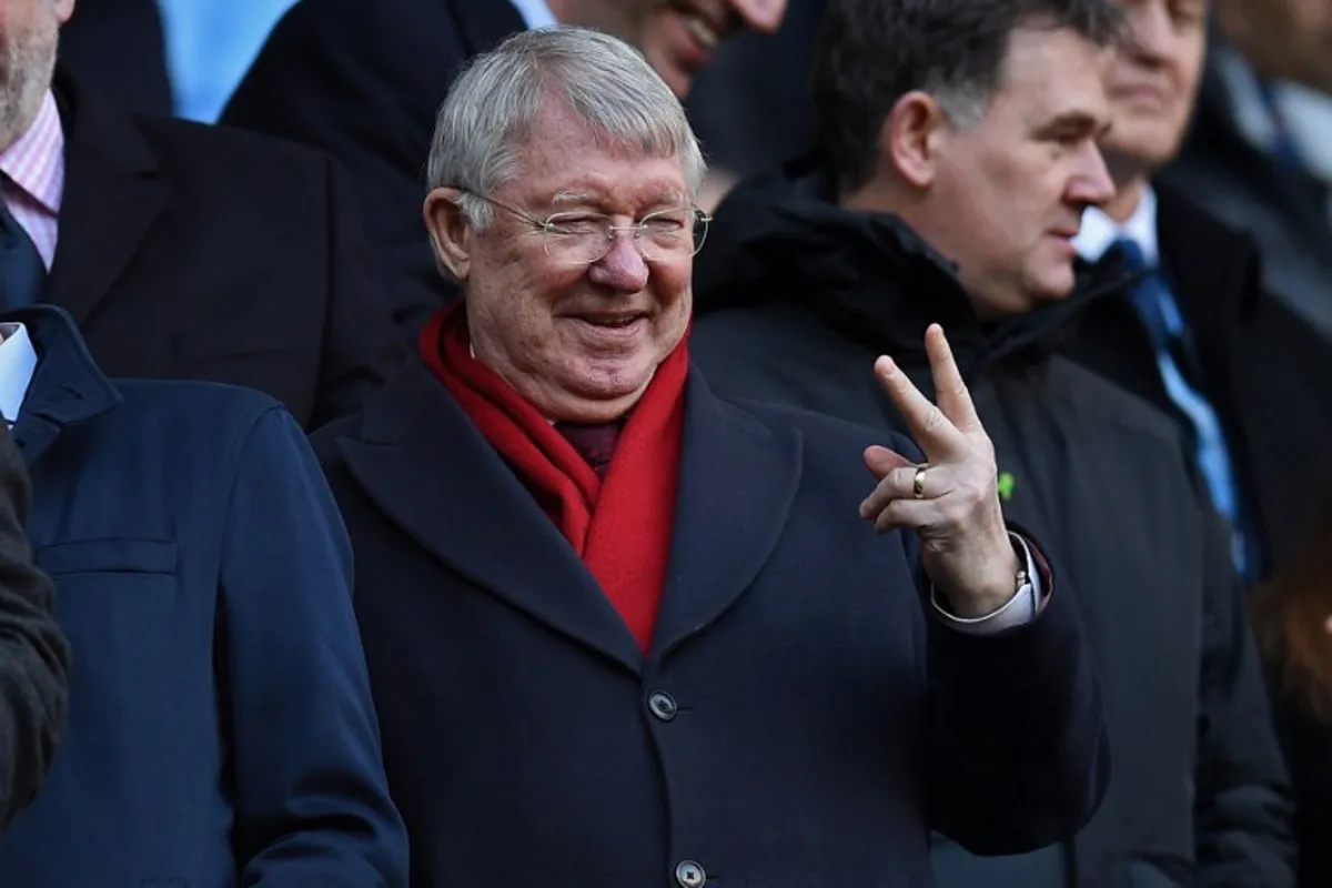 Manchester United's former manager Alex Ferguson gestures as he takes his seat for the English Premier League football match between Manchester City and Manchester United at the Etihad Stadium in Manchester, north west England, on March 6, 2022.  Oli SCARFF / AFP