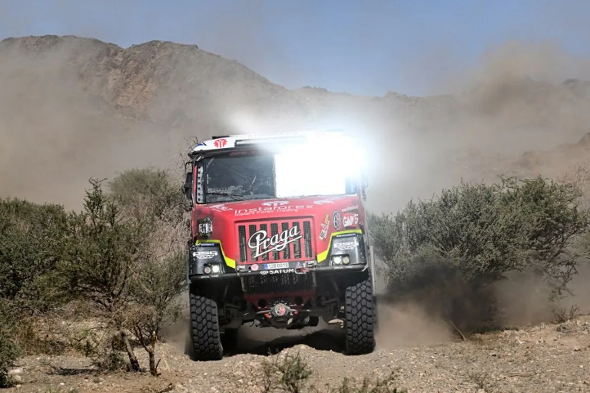 Instaforex Loprais Praga's Czech driver Ales Loprais, co-driver Jaroslav Valtr, and mechanic Jiri Stross steer their truck during stage 7 between Riyad and Al Duwadimi on January 14, 2024, as part of the Dakar rally 2024.  PATRICK HERTZOG / AFP