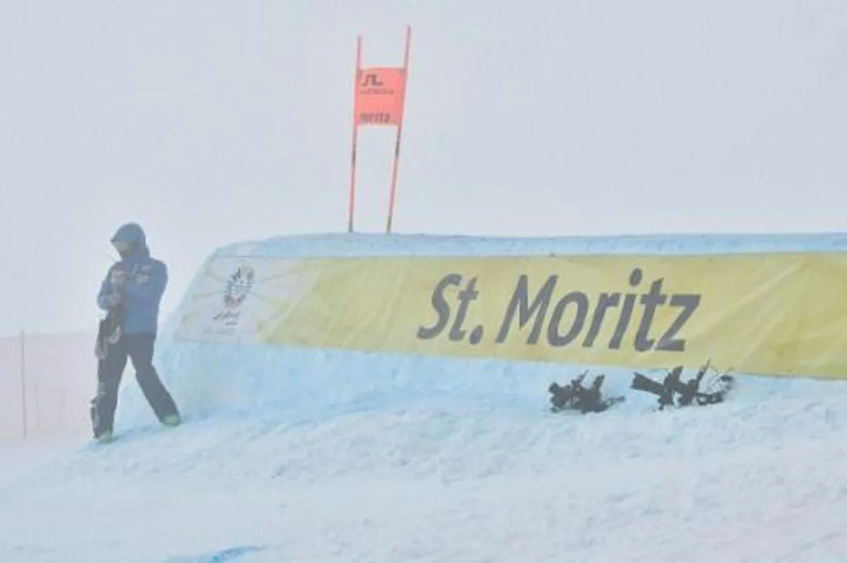 An FIS official speaks on a radio as the start of the race is delayed due to fog before the men's downhill race at the 2017 FIS Alpine World Ski Championships in St Moritz on February 11, 2017. 
Fabrice COFFRINI / AFP