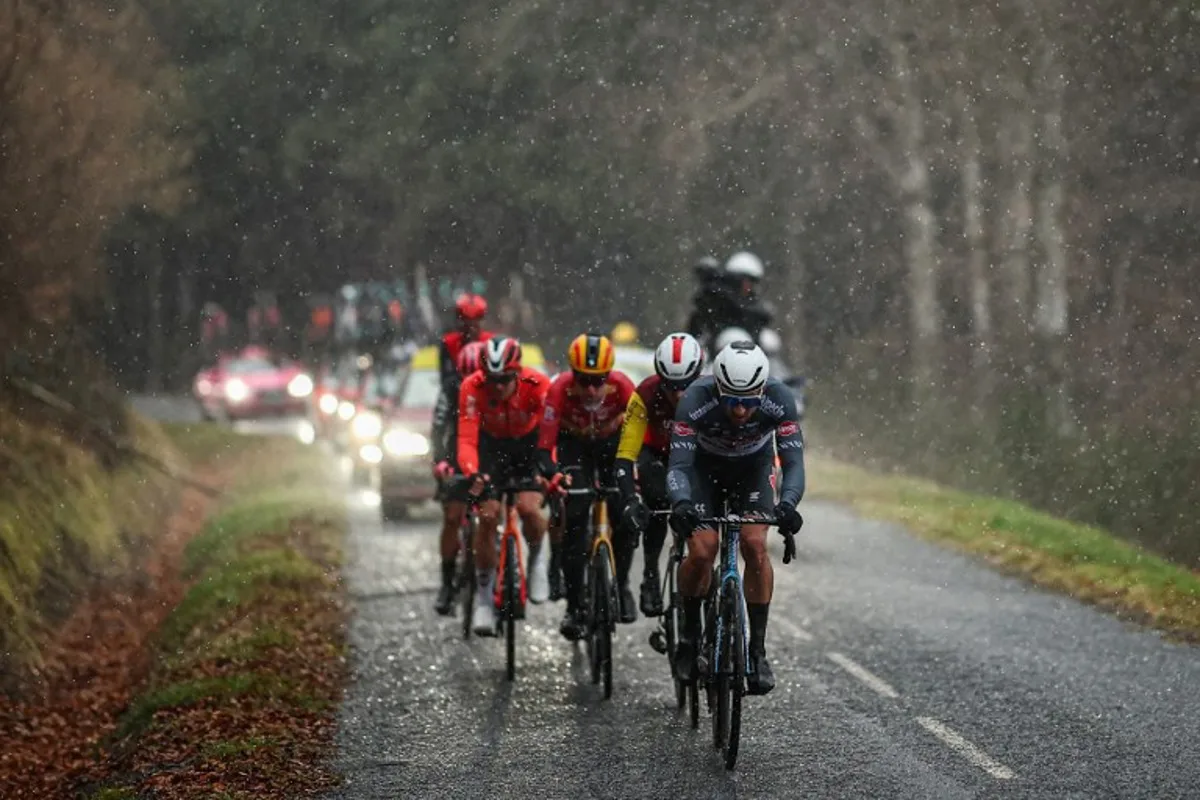 Alpecin-Deceuninck's Belgian rider Edward Planckaert (R) cycles leading a breakaway under the rain during the 4th stage of the Paris-Nice cycling race, 163,4 km between Vichy and La Loge des Gardes, on March 12, 2025.  Anne-Christine POUJOULAT / AFP